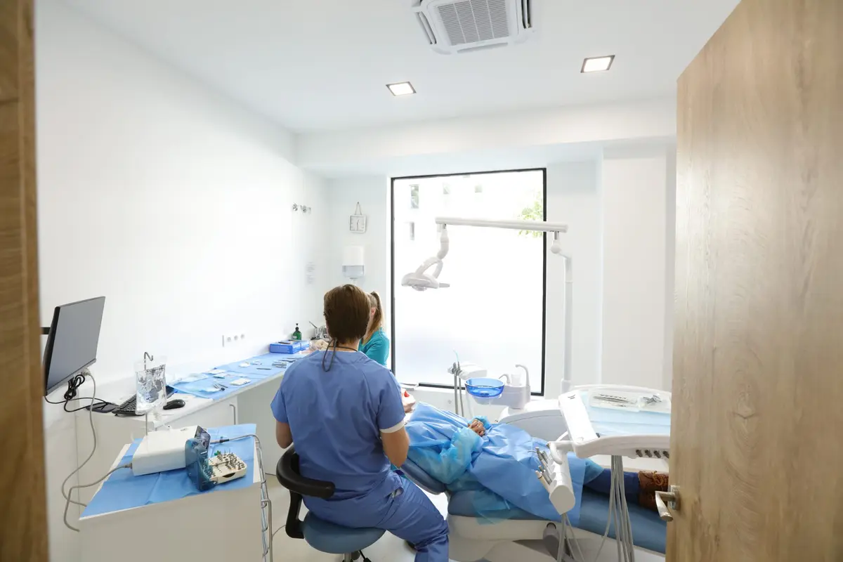 A clinician working alone in one of the operatories